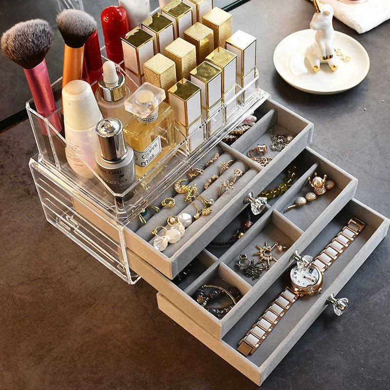 A clear acrylic jewelry organizer featuring multiple compartments and drawers, designed to neatly store and display rings, necklaces, bracelets, and earrings. Its transparent design allows for easy visibility of contents, while the compact structure fits seamlessly on a vanity or dresser, keeping accessories organized and easily accessible