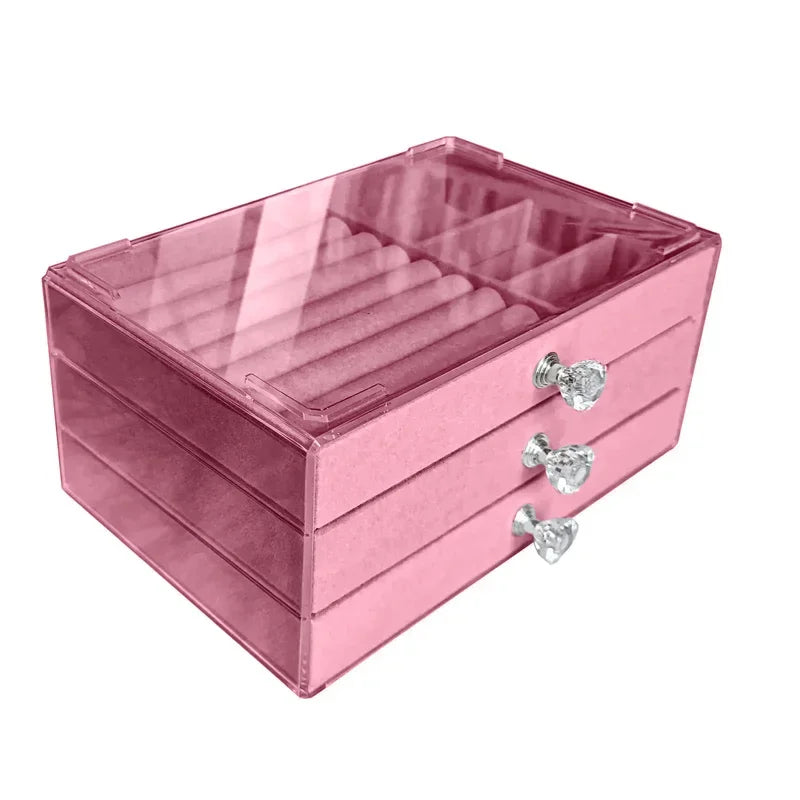 A clear acrylic jewelry organizer featuring multiple compartments and drawers, designed to neatly store and display rings, necklaces, bracelets, and earrings. Its transparent design allows for easy visibility of contents, while the compact structure fits seamlessly on a vanity or dresser, keeping accessories organized and easily accessible
