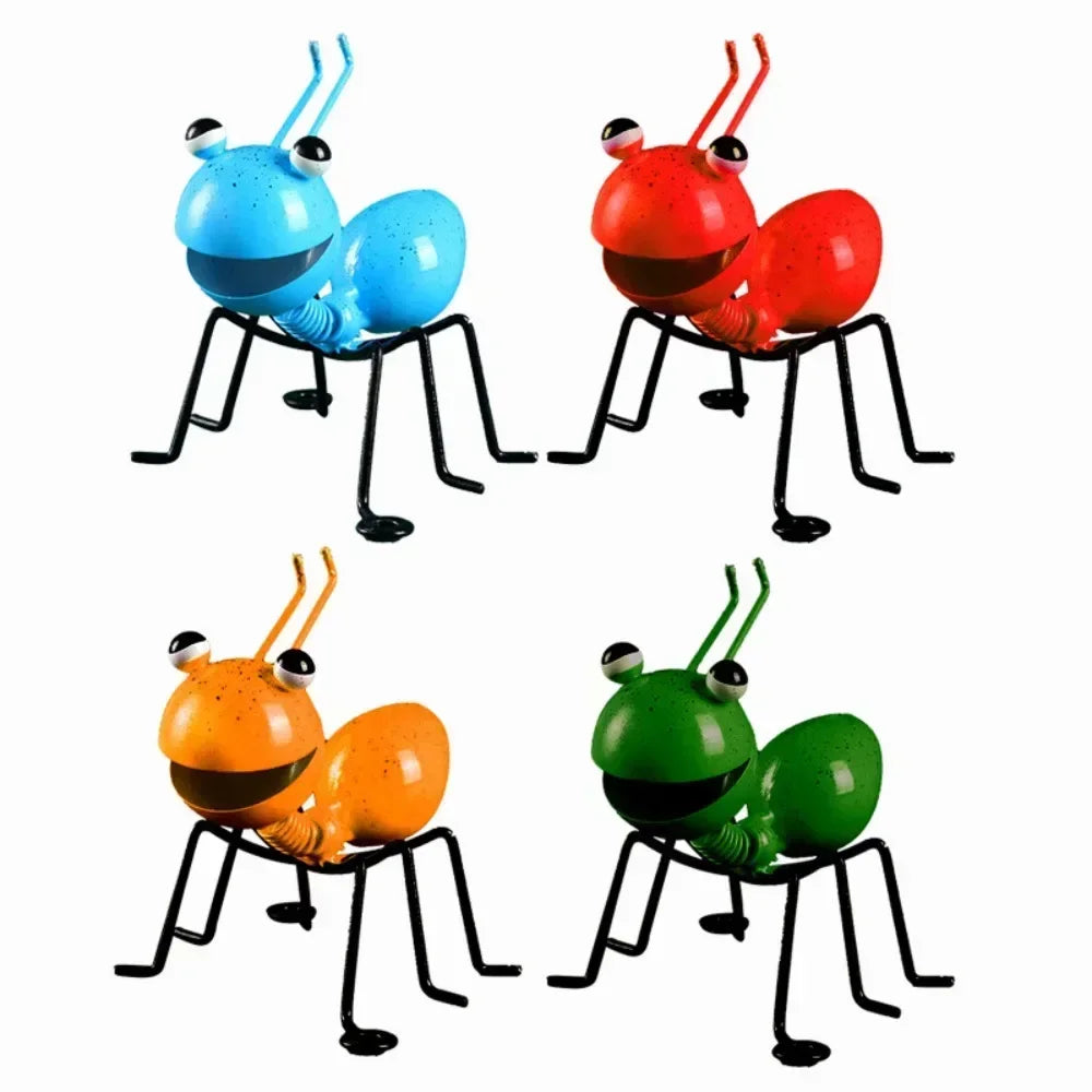 A whimsical metal ant sculpture designed as a garden ornament. The ant features a rustic finish, detailed body segments, and expressive antennae, adding a touch of charm and playfulness to outdoor spaces