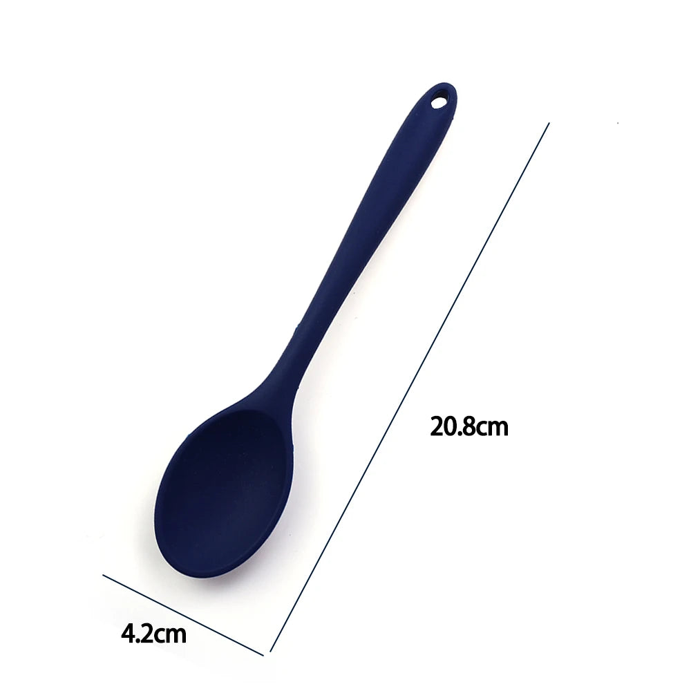 A soft silicone spoon designed for stirring, featuring a flexible, heat-resistant head that protects non-stick cookware. The ergonomic handle ensures a comfortable grip, making it ideal for mixing, scooping, and serving a variety of dishes