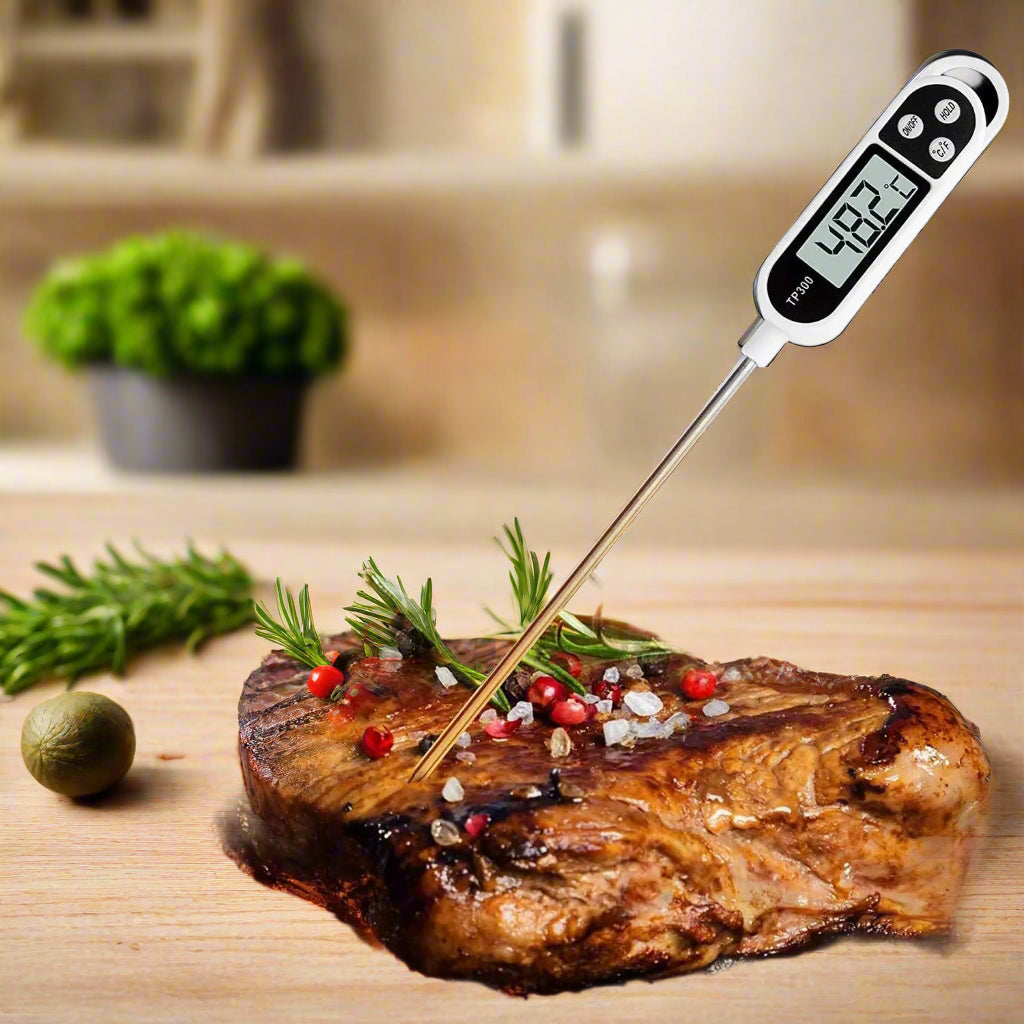 Digital food thermometer with a stainless steel probe and backlit LCD display, providing instant and accurate temperature readings for meats and other dishes