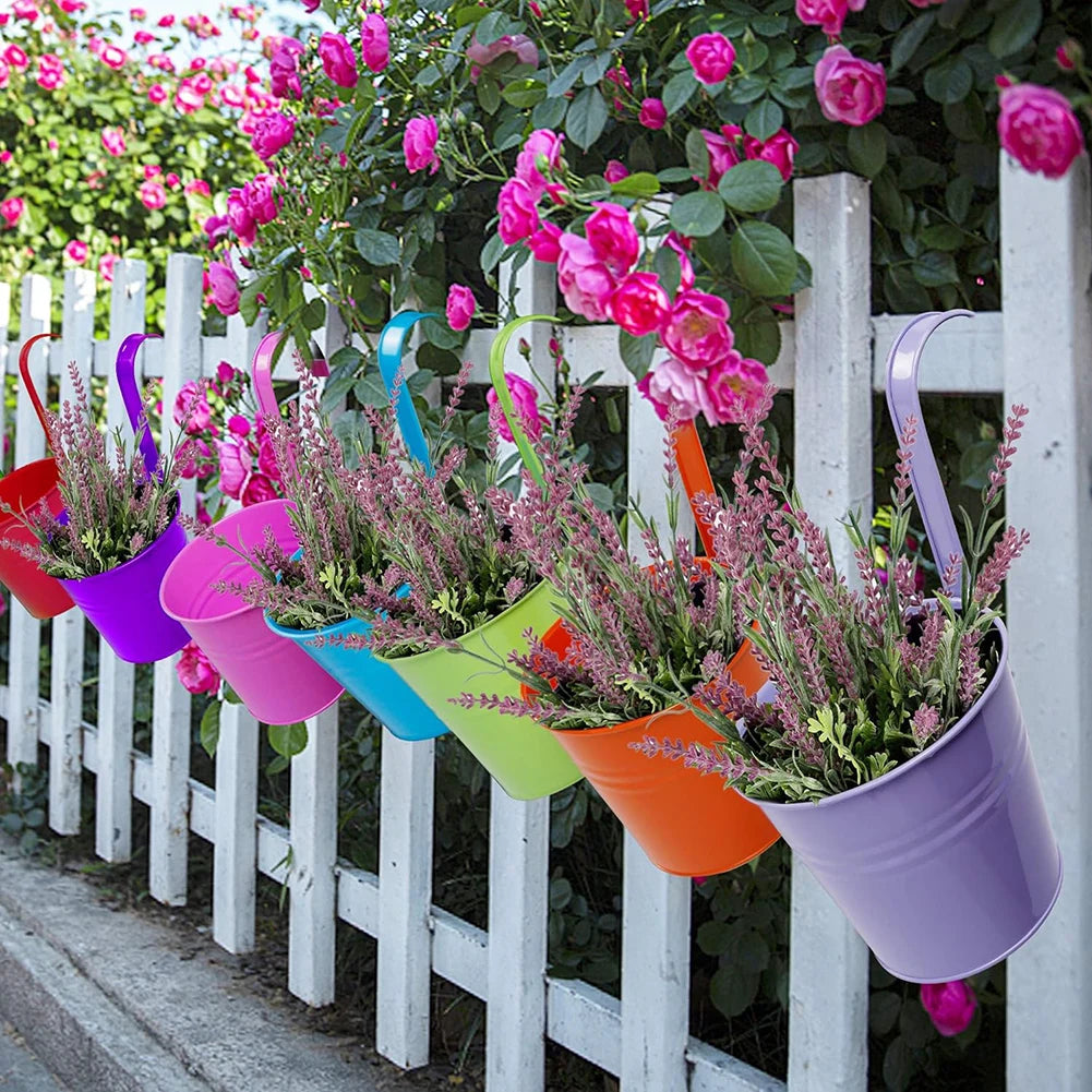 A set of colorful metal iron hanging flower pots with detachable hooks, designed to hang on balconies, fences, or garden railings; ideal for displaying vibrant flowers or plants, adding charm and greenery to outdoor spaces