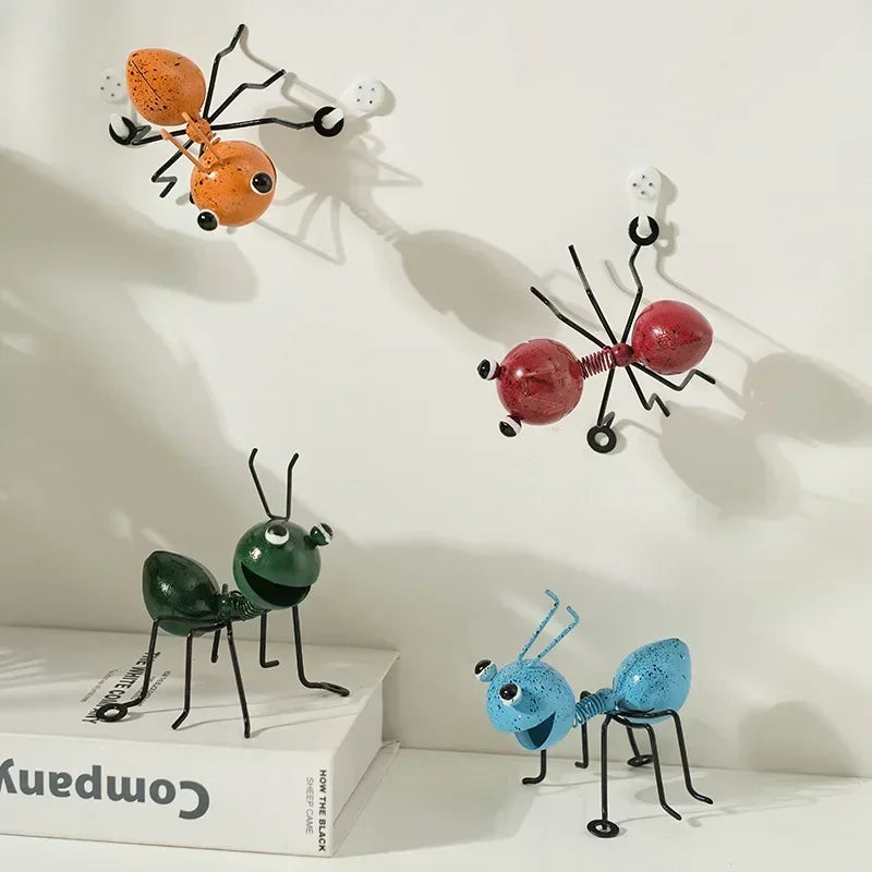 A whimsical metal ant sculpture designed as a garden ornament. The ant features a rustic finish, detailed body segments, and expressive antennae, adding a touch of charm and playfulness to outdoor spaces