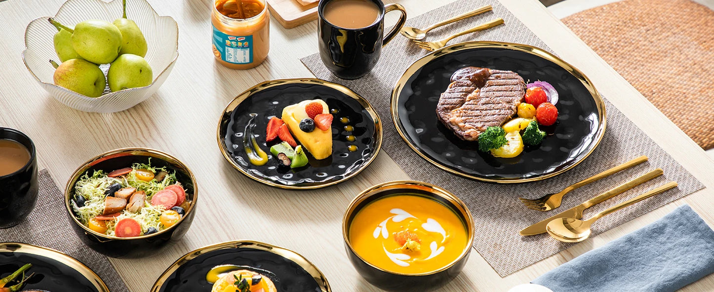 A sophisticated black porcelain dinnerware set featuring elegant gold trim accents. This set typically includes dinner plates, salad plates, bowls, and mugs, all crafted from high-quality porcelain. The combination of deep black hues with refined gold detailing adds a touch of luxury to both everyday dining and special occasions