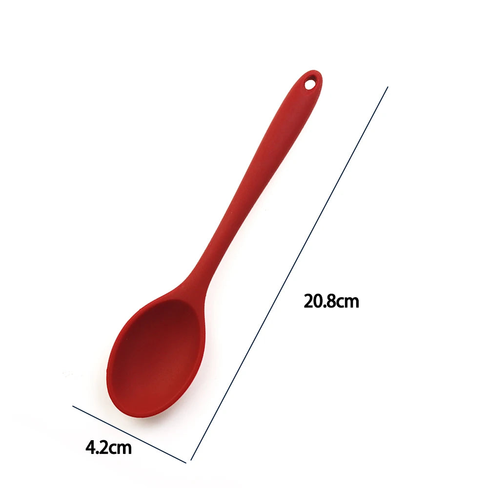 A soft silicone spoon designed for stirring, featuring a flexible, heat-resistant head that protects non-stick cookware. The ergonomic handle ensures a comfortable grip, making it ideal for mixing, scooping, and serving a variety of dishes