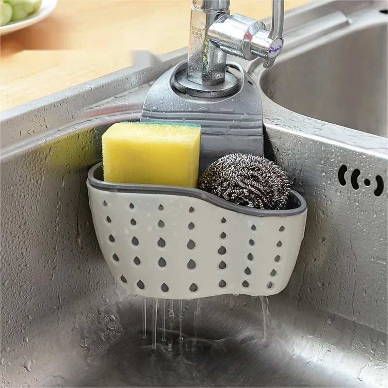 A double-layer sink hanging organizer made of durable materials, featuring two compartments for storing sponges, brushes, and other cleaning tools. Designed to hang over the sink or faucet, it provides convenient storage and quick drainage, keeping the countertop clutter-free