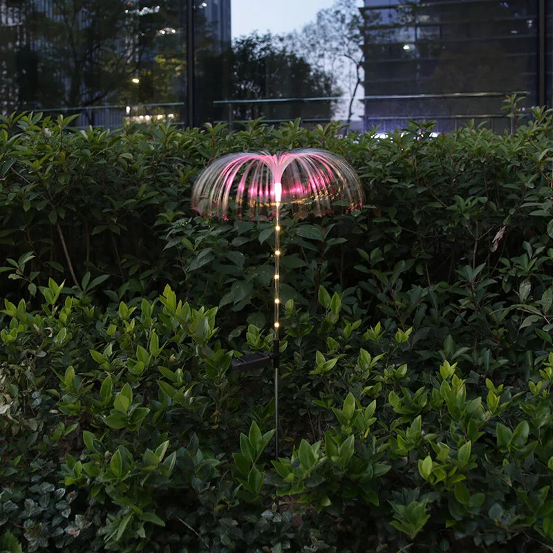 A solar-powered fiber optic lamp featuring multi-color illumination. The lamp harnesses sunlight during the day to power vibrant, color-changing fiber optic strands at night, creating a mesmerizing display suitable for gardens, patios, or outdoor pathways.