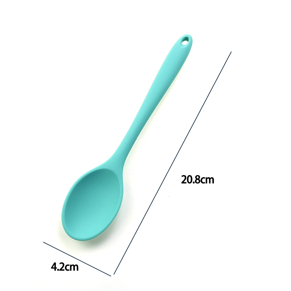 A soft silicone spoon designed for stirring, featuring a flexible, heat-resistant head that protects non-stick cookware. The ergonomic handle ensures a comfortable grip, making it ideal for mixing, scooping, and serving a variety of dishes