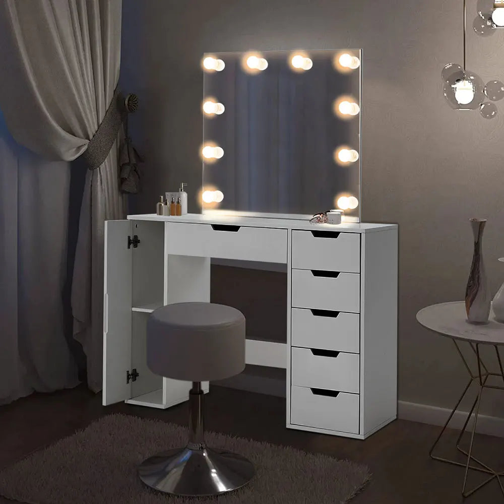 A stylish Hollywood makeup dressing table with bright LED lights around the mirror, offering a well-lit space for makeup application. The table features a sleek design with ample storage space for cosmetics and beauty tools.