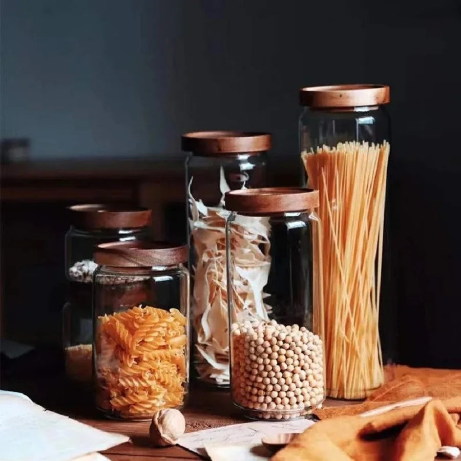 A collection of clear glass storage jars with airtight lids, ideal for organizing and preserving various kitchen staples such as pasta, grains, spices, and snacks. Their transparent design allows for easy identification of contents, while the airtight seals maintain freshness and prevent moisture intrusion. These jars not only provide practical storage solutions but also add a touch of elegance to kitchen countertops or pantry shelves