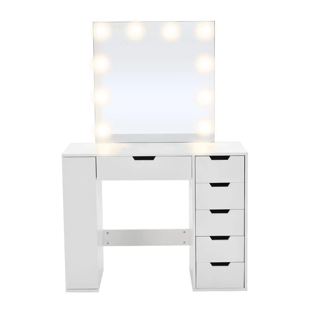 A stylish Hollywood makeup dressing table with bright LED lights around the mirror, offering a well-lit space for makeup application. The table features a sleek design with ample storage space for cosmetics and beauty tools.