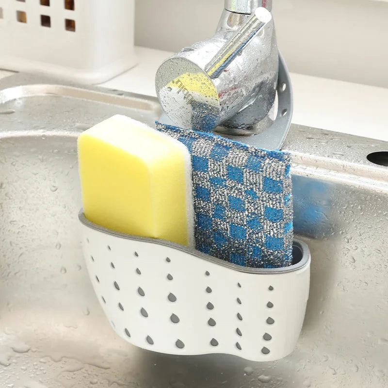 A double-layer sink hanging organizer made of durable materials, featuring two compartments for storing sponges, brushes, and other cleaning tools. Designed to hang over the sink or faucet, it provides convenient storage and quick drainage, keeping the countertop clutter-free