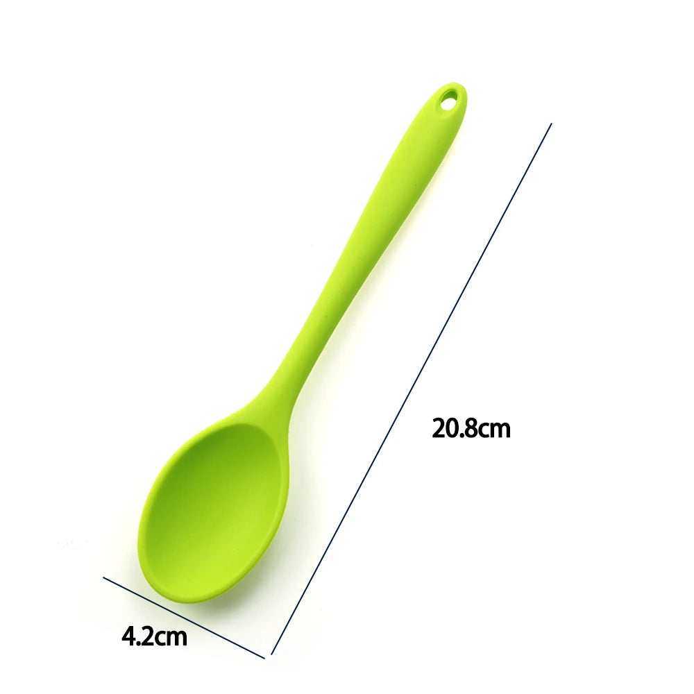 A soft silicone spoon designed for stirring, featuring a flexible, heat-resistant head that protects non-stick cookware. The ergonomic handle ensures a comfortable grip, making it ideal for mixing, scooping, and serving a variety of dishes