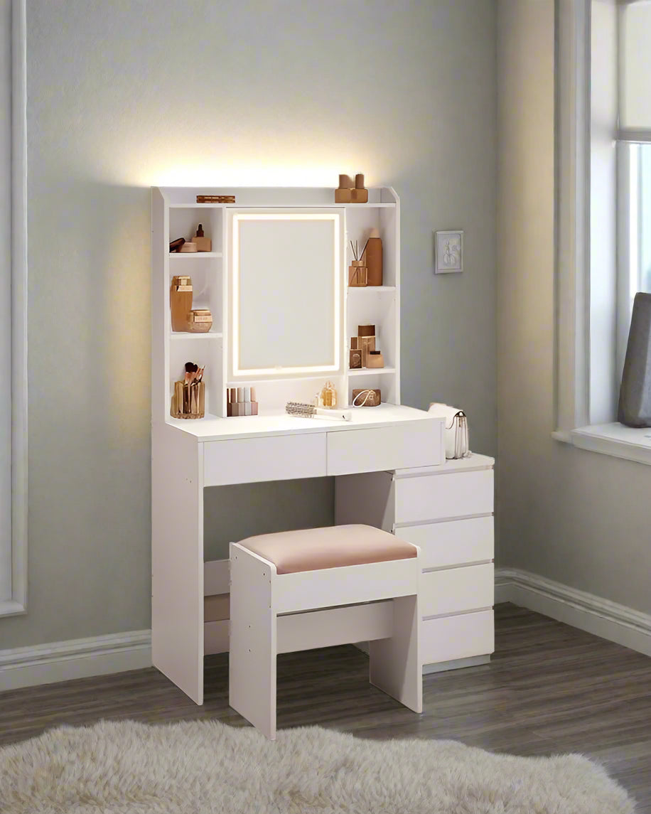 A modern vanity table featuring a sleek design, equipped with a built-in LED-lit mirror offering adjustable brightness settings. The table includes multiple drawers and shelves for organized storage of cosmetics and accessories, complemented by a smooth tabletop for a stylish and functional addition to any bedroom or dressing area.