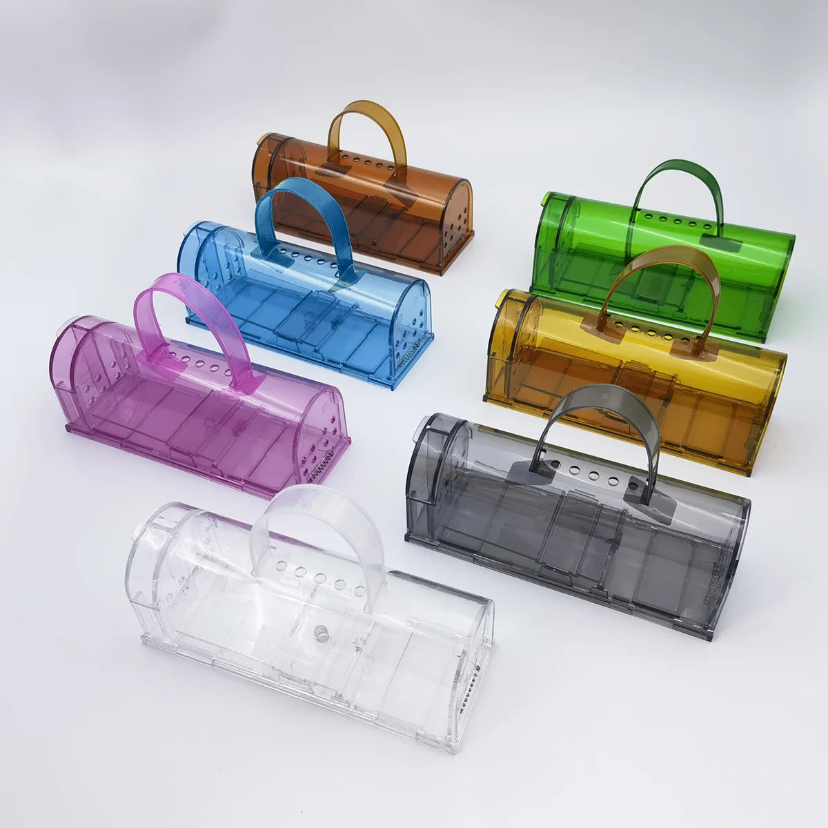 A humane mouse trap designed to safely capture and release mice without harm. The transparent plastic construction allows for easy monitoring, and ventilation holes ensure the mouse's well-being until release