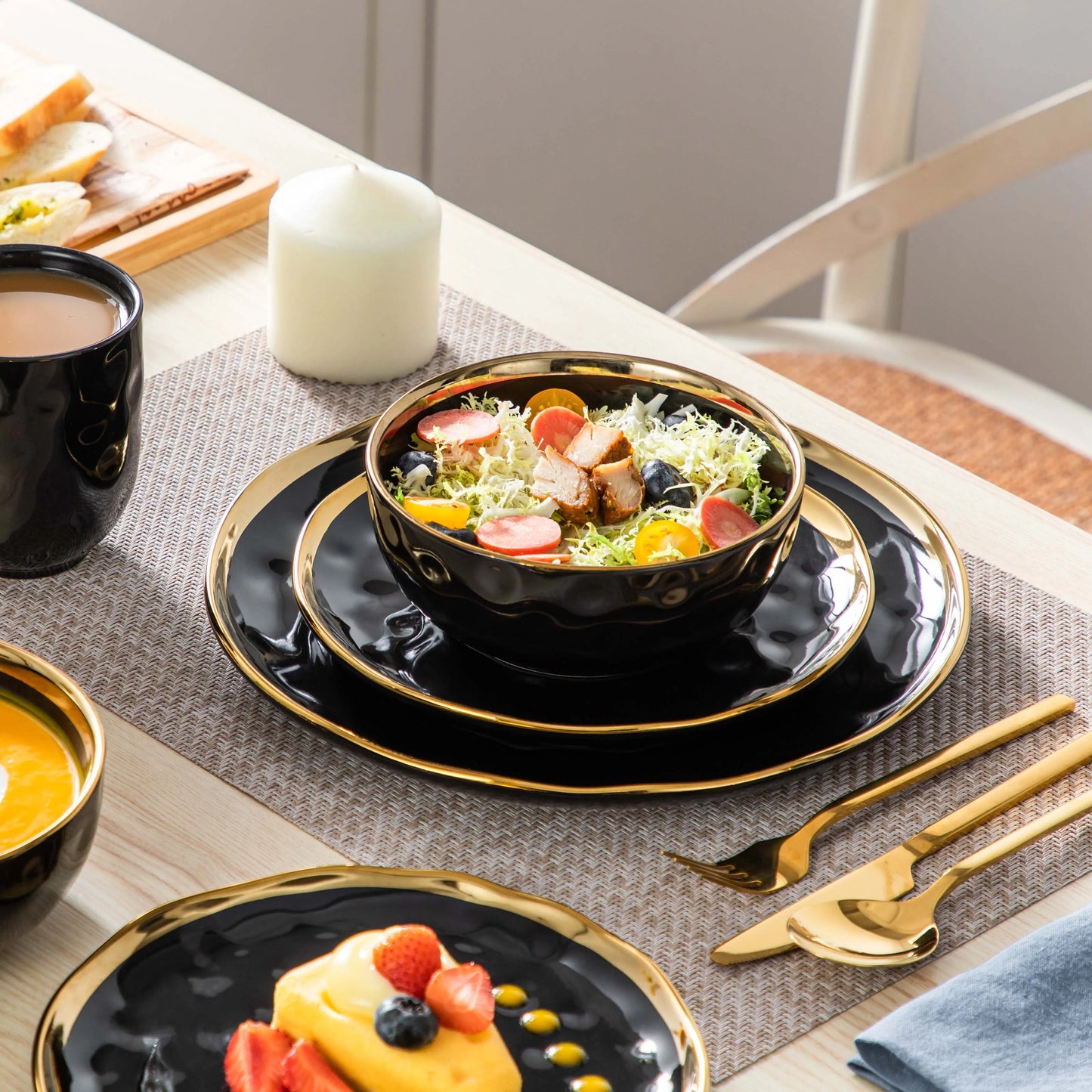 A sophisticated black porcelain dinnerware set featuring elegant gold trim accents. This set typically includes dinner plates, salad plates, bowls, and mugs, all crafted from high-quality porcelain. The combination of deep black hues with refined gold detailing adds a touch of luxury to both everyday dining and special occasions