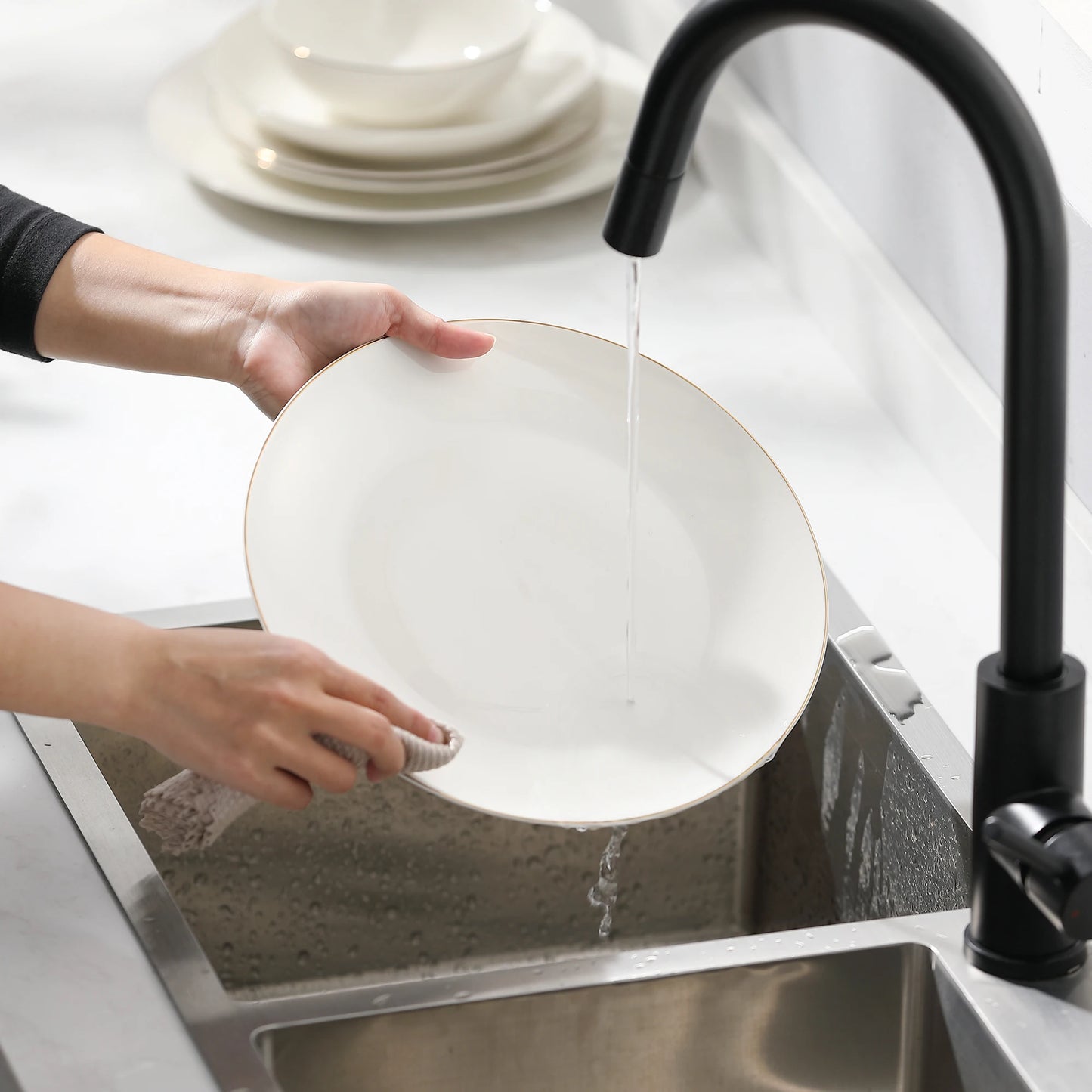 A complete dinnerware set including dinner plates, salad plates, bowls, and mugs, all featuring a sleek, modern design in a neutral color palette