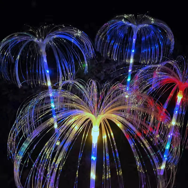 A solar-powered fiber optic lamp featuring multi-color illumination. The lamp harnesses sunlight during the day to power vibrant, color-changing fiber optic strands at night, creating a mesmerizing display suitable for gardens, patios, or outdoor pathways.