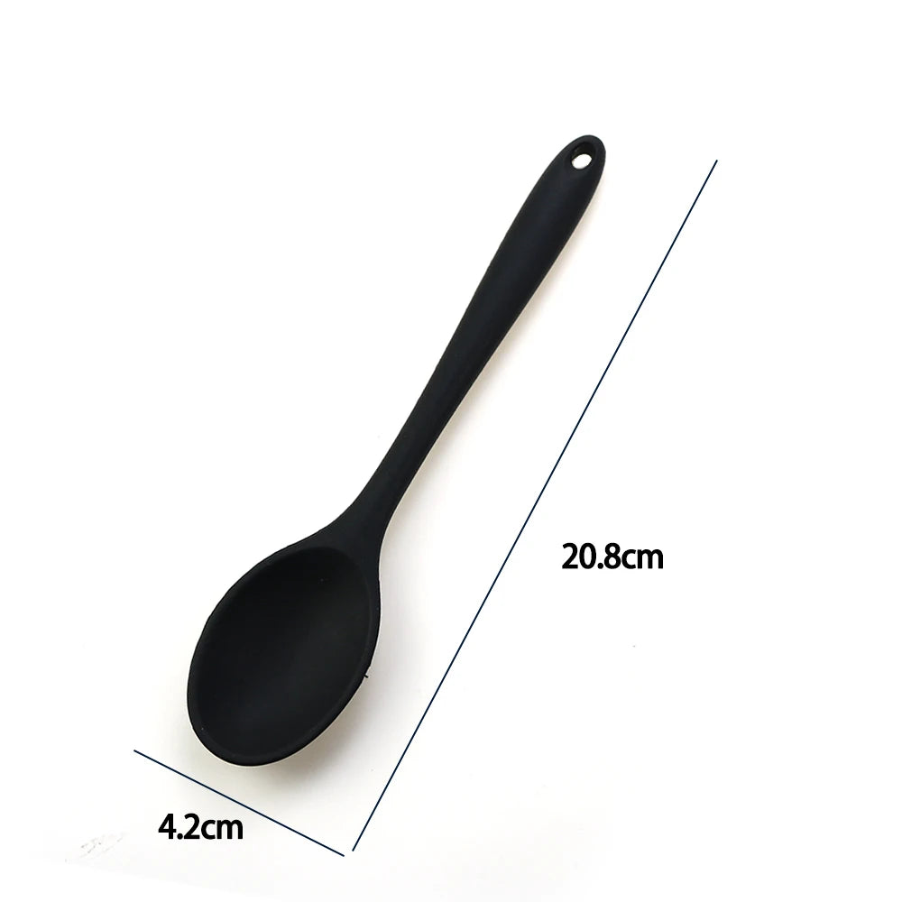 A soft silicone spoon designed for stirring, featuring a flexible, heat-resistant head that protects non-stick cookware. The ergonomic handle ensures a comfortable grip, making it ideal for mixing, scooping, and serving a variety of dishes