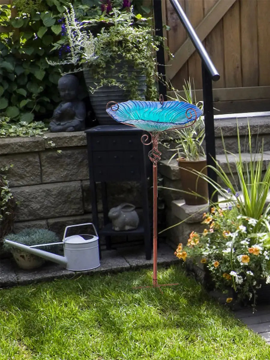 A decorative garden birdbath featuring a glass bowl with a flower design, mounted on a tall pedestal. The vibrant colors and intricate patterns attract birds while adding a touch of elegance to outdoor spaces.