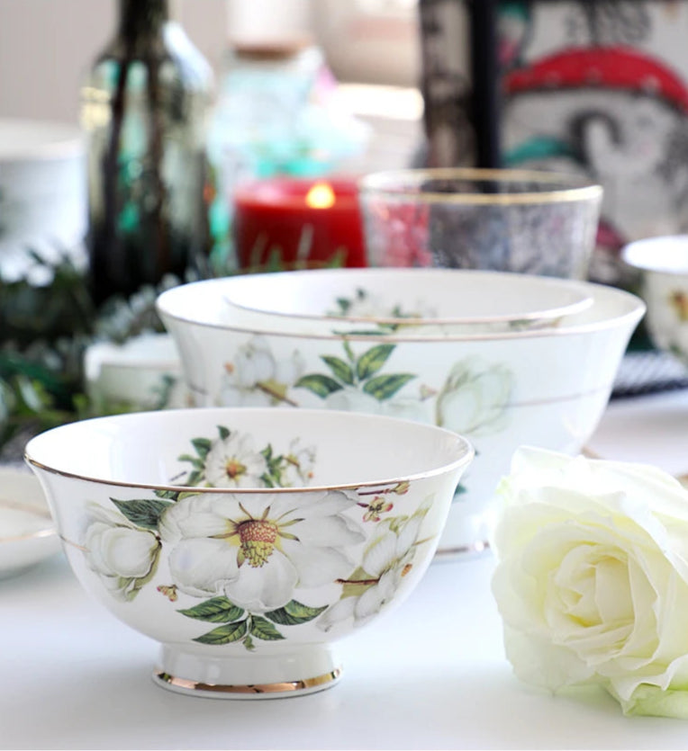 A set of bone china dinnerware comprising dinner plates, salad plates, bowls, and cups, all crafted from high-quality porcelain infused with bone ash. Renowned for its exceptional whiteness, translucency, and strength, bone china offers a luxurious feel and elegant appearance. This timeless collection is perfect for enhancing both everyday meals and special occasions