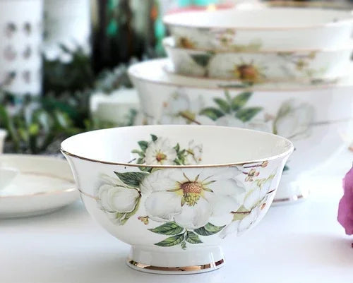 A set of bone dinnerware comprising dinner plates, salad plates, bowls, and cups, all crafted from high-quality porcelain infused with bone ash. Renowned for its exceptional whiteness, translucency, and strength, bone china offers a luxurious feel and elegant appearance. This timeless collection is perfect for enhancing both everyday meals and special occasions