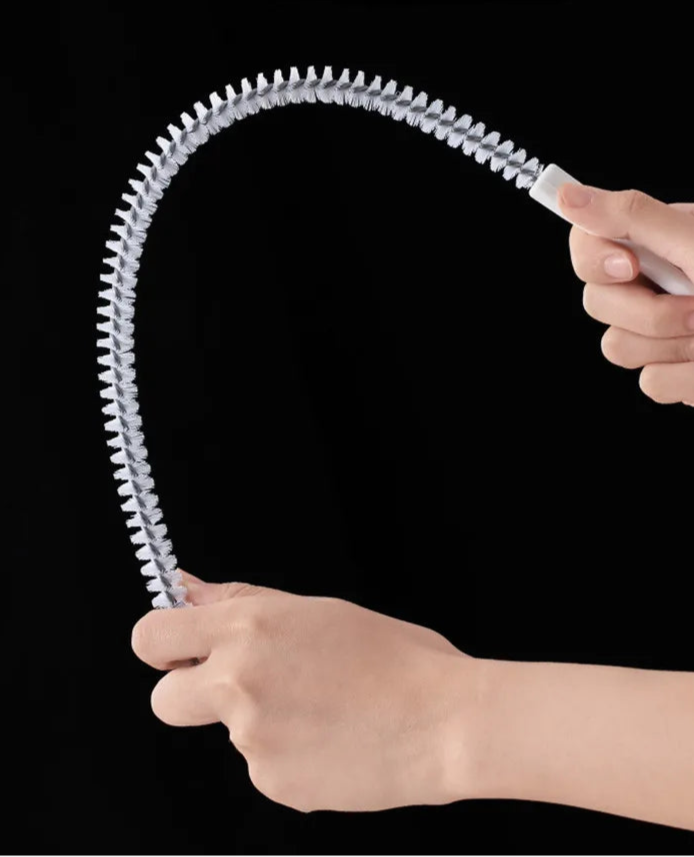 A flexible pipe dredging brush designed to clean the interior of pipes and drains. It features durable bristles attached to a long, bendable handle, allowing it to navigate through curves and remove debris, ensuring optimal water flow