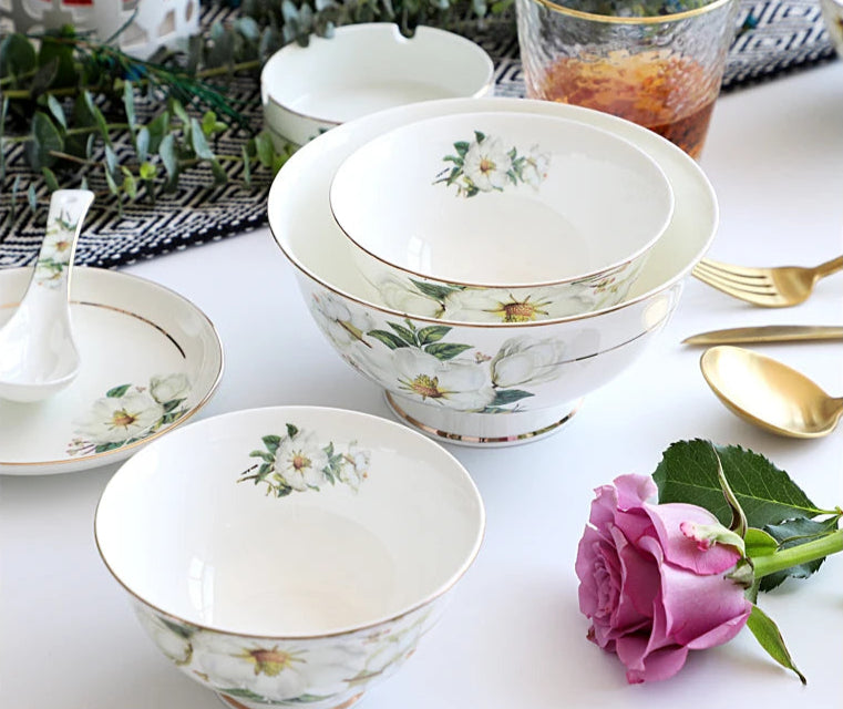 A set of bone china dinnerware comprising dinner plates, salad plates, bowls, and cups, all crafted from high-quality porcelain infused with bone ash. Renowned for its exceptional whiteness, translucency, and strength, bone china offers a luxurious feel and elegant appearance. This timeless collection is perfect for enhancing both everyday meals and special occasions