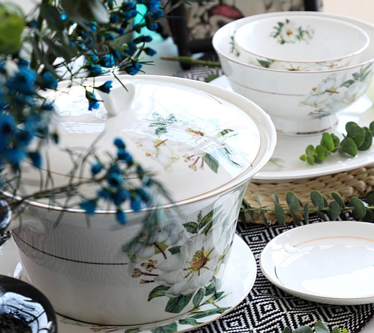 A set of bone china dinnerware comprising dinner plates, salad plates, bowls, and cups, all crafted from high-quality porcelain infused with bone ash. Renowned for its exceptional whiteness, translucency, and strength, bone china offers a luxurious feel and elegant appearance. This timeless collection is perfect for enhancing both everyday meals and special occasions
