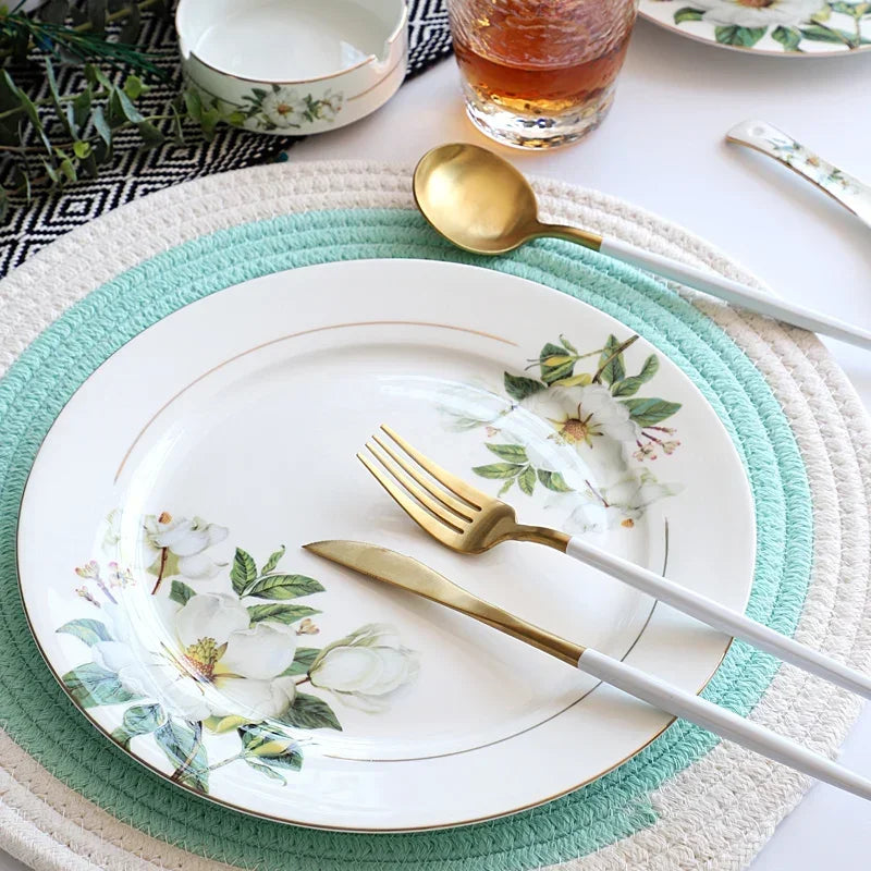 A set of bone china dinnerware comprising dinner plates, salad plates, bowls, and cups, all crafted from high-quality porcelain infused with bone ash. Renowned for its exceptional whiteness, translucency, and strength, bone china offers a luxurious feel and elegant appearance. This timeless collection is perfect for enhancing both everyday meals and special occasions