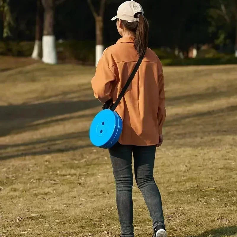 A portable round folding chair featuring a lightweight, collapsible frame and a circular seat, designed for easy transport and storage. Ideal for camping, outdoor events, or additional seating needs, this chair offers convenience and comfort with its compact design and sturdy construction.