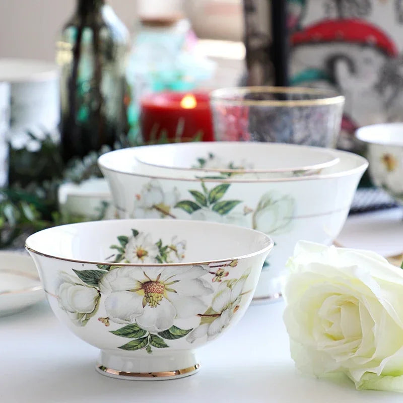 A set of bone china dinnerware comprising dinner plates, salad plates, bowls, and cups, all crafted from high-quality porcelain infused with bone ash. Renowned for its exceptional whiteness, translucency, and strength, bone china offers a luxurious feel and elegant appearance. This timeless collection is perfect for enhancing both everyday meals and special occasions