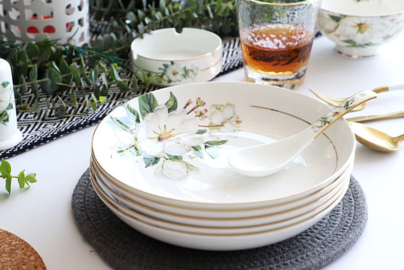 A set of bone china dinnerware comprising dinner plates, salad plates, bowls, and cups, all crafted from high-quality porcelain infused with bone ash. Renowned for its exceptional whiteness, translucency, and strength, bone china offers a luxurious feel and elegant appearance. This timeless collection is perfect for enhancing both everyday meals and special occasions