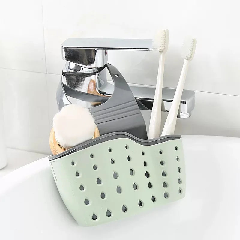 A double-layer sink hanging organizer made of durable materials, featuring two compartments for storing sponges, brushes, and other cleaning tools. Designed to hang over the sink or faucet, it provides convenient storage and quick drainage, keeping the countertop clutter-free