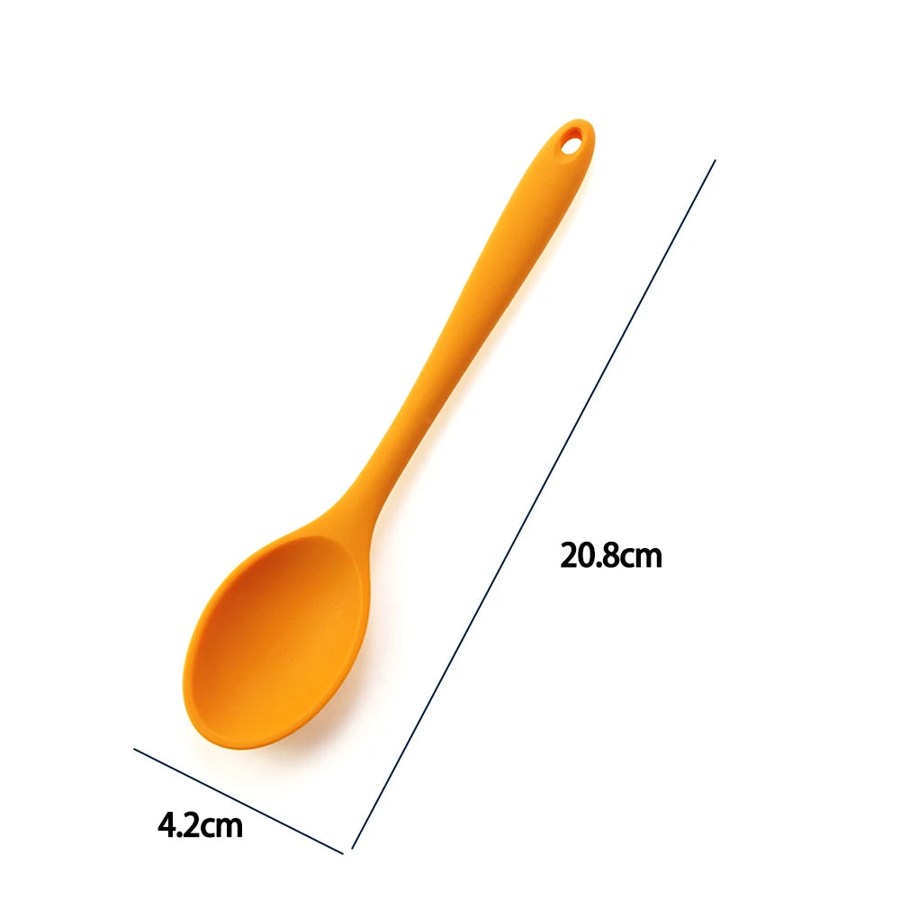 A soft silicone spoon designed for stirring, featuring a flexible, heat-resistant head that protects non-stick cookware. The ergonomic handle ensures a comfortable grip, making it ideal for mixing, scooping, and serving a variety of dishes
