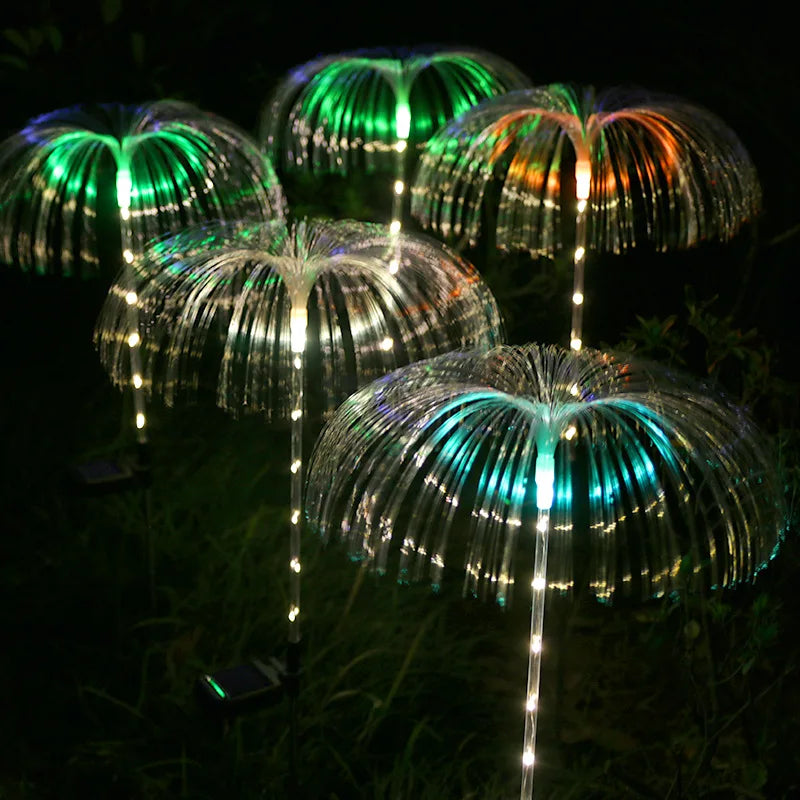 A solar-powered fiber optic lamp featuring multi-color illumination. The lamp harnesses sunlight during the day to power vibrant, color-changing fiber optic strands at night, creating a mesmerizing display suitable for gardens, patios, or outdoor pathways.