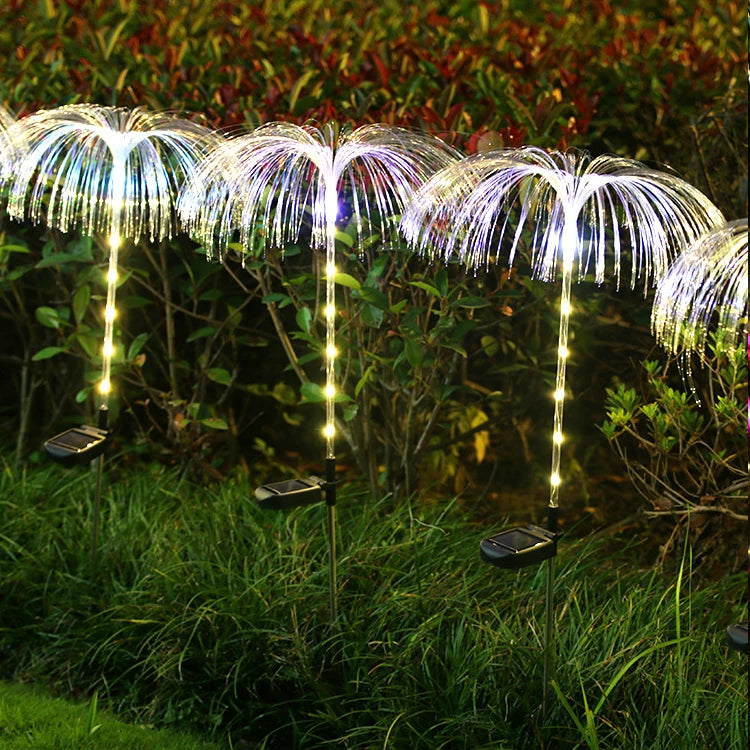 A solar-powered fiber optic lamp featuring multi-color illumination. The lamp harnesses sunlight during the day to power vibrant, color-changing fiber optic strands at night, creating a mesmerizing display suitable for gardens, patios, or outdoor pathways.