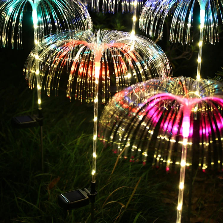 A solar-powered fiber optic lamp featuring multi-color illumination. The lamp harnesses sunlight during the day to power vibrant, color-changing fiber optic strands at night, creating a mesmerizing display suitable for gardens, patios, or outdoor pathways.