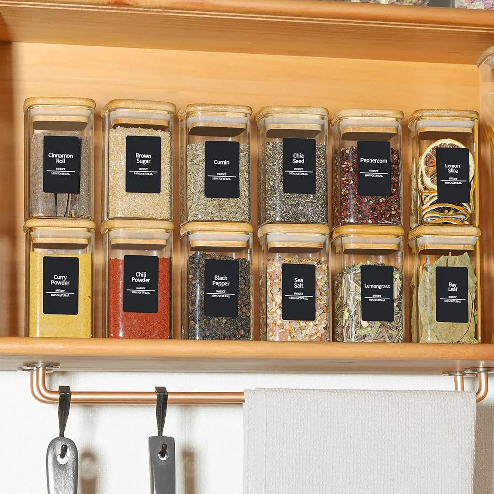 Set of glass spice jars with bamboo lids, offering a stylish and eco-friendly storage solution. Perfect for organizing and preserving spices, herbs, or other kitchen essentials.