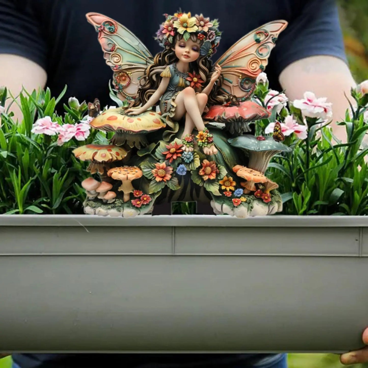 A delicate fairy figurine crafted from high-quality resin, featuring intricate detailing and a hand-painted finish. The figurine depicts a graceful fairy with translucent wings, poised elegantly on a floral base, adding a touch of enchantment to any space.