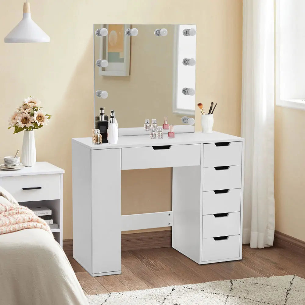 A stylish Hollywood makeup dressing table with bright LED lights around the mirror, offering a well-lit space for makeup application. The table features a sleek design with ample storage space for cosmetics and beauty tools.