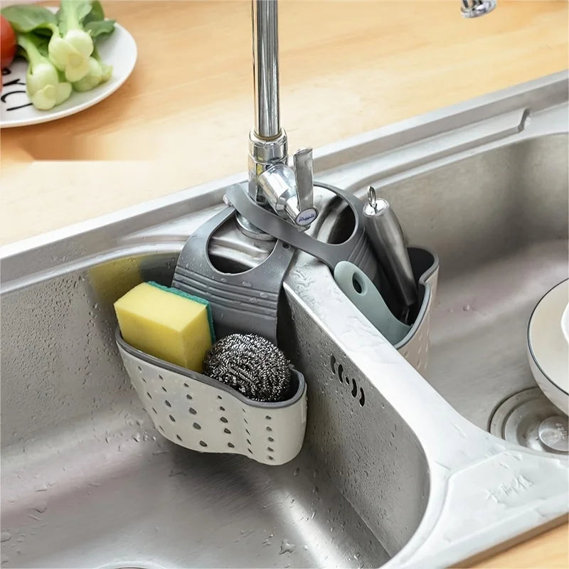 A double-layer sink hanging organizer made of durable materials, featuring two compartments for storing sponges, brushes, and other cleaning tools. Designed to hang over the sink or faucet, it provides convenient storage and quick drainage, keeping the countertop clutter-free