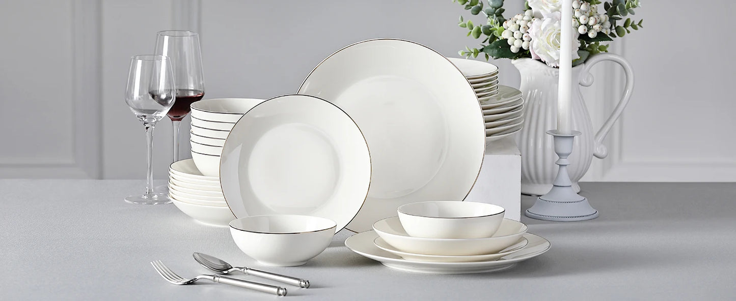 A complete dinnerware set including dinner plates, salad plates, bowls, and mugs, all featuring a sleek, modern design in a neutral color palette