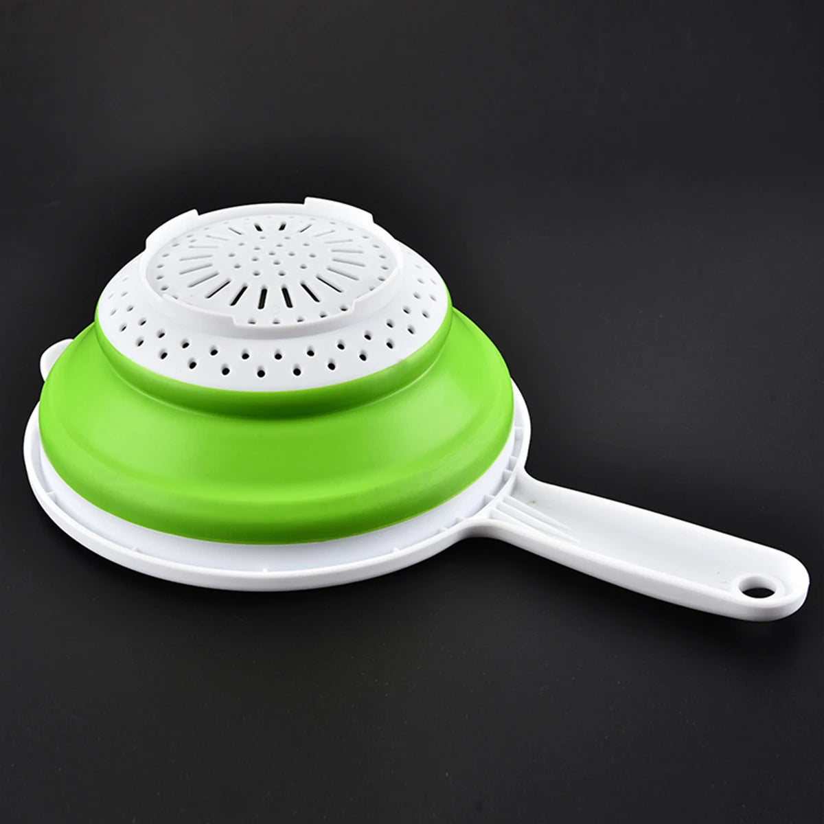 Collapsible draining basket for vegetables, made from durable silicone; features foldable design for space-saving storage, integrated handles for easy handling, and perforated base for efficient draining