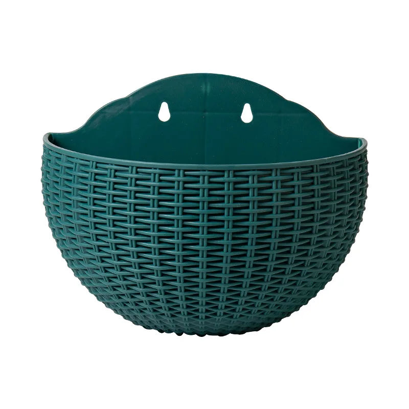 A durable plastic wall-mounted hanging planter in a half-round design, securely attached to a balcony railing. It is filled with vibrant blooming flowers, adding a touch of nature and color to the outdoor space.