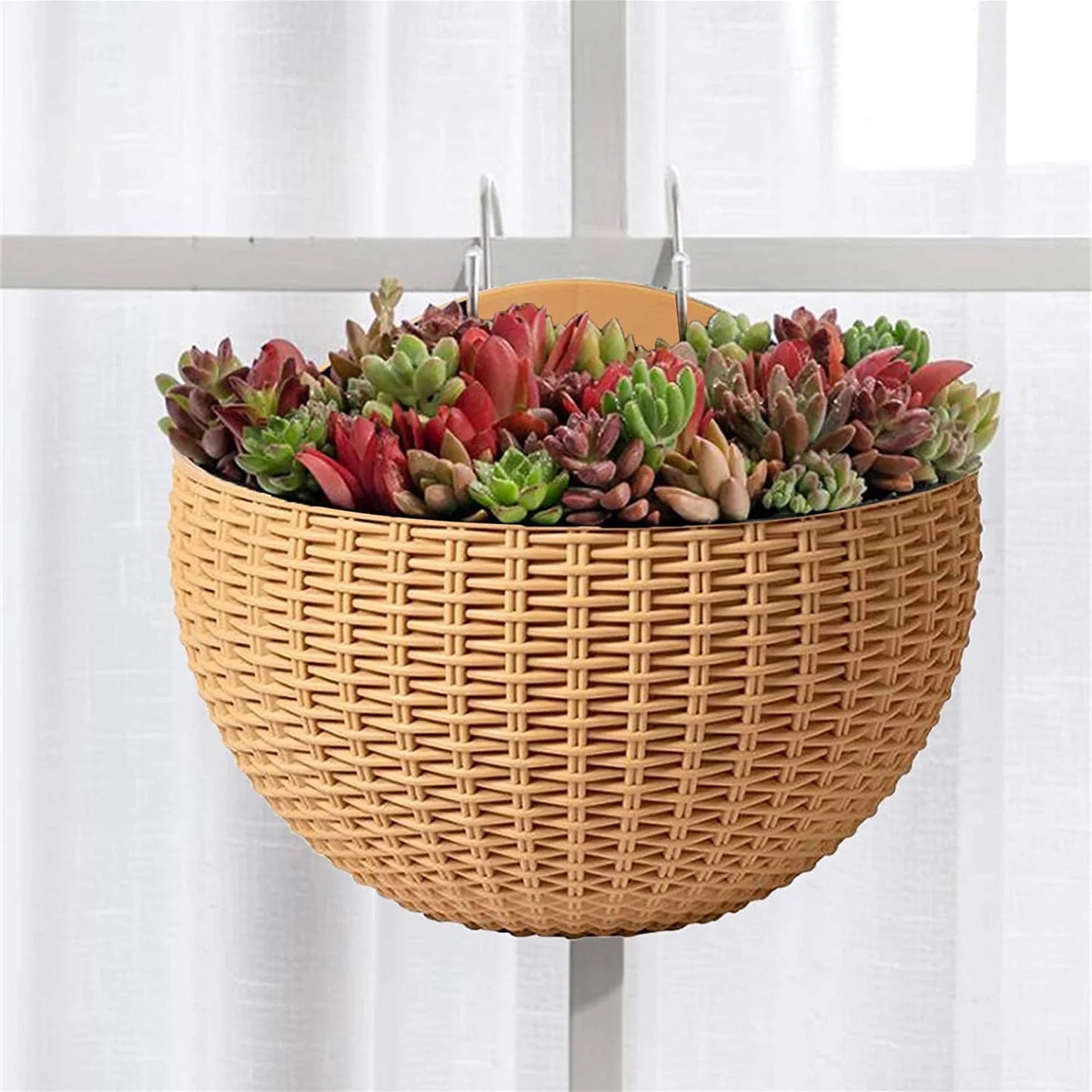 A durable plastic wall-mounted hanging planter in a half-round design, securely attached to a balcony railing. It is filled with vibrant blooming flowers, adding a touch of nature and color to the outdoor space.