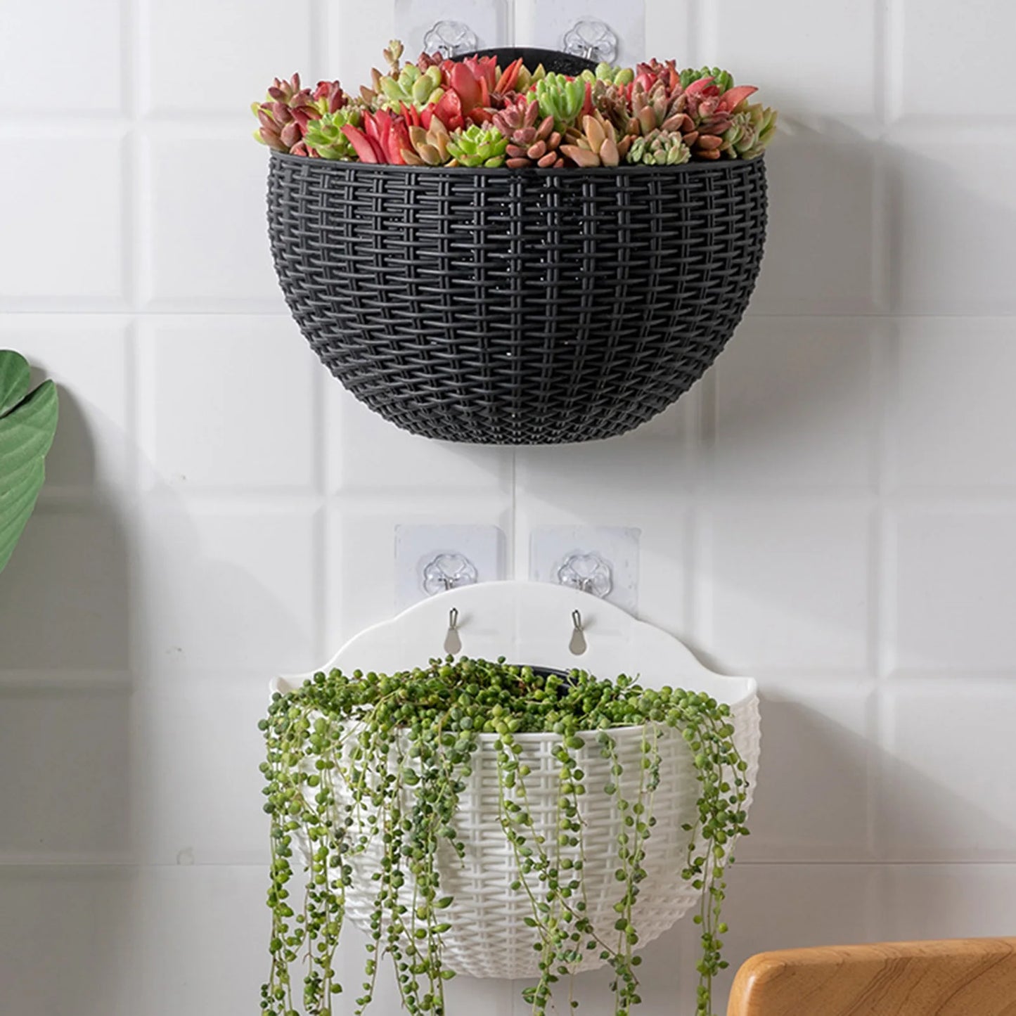 A durable plastic wall-mounted hanging planter in a half-round design, securely attached to a balcony railing. It is filled with vibrant blooming flowers, adding a touch of nature and color to the outdoor space.